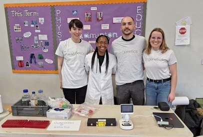 four people standing behind a table at a STEM event