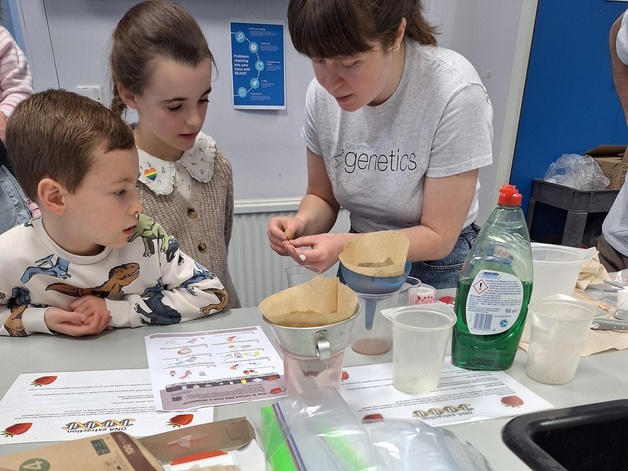 scientist showing children a sample