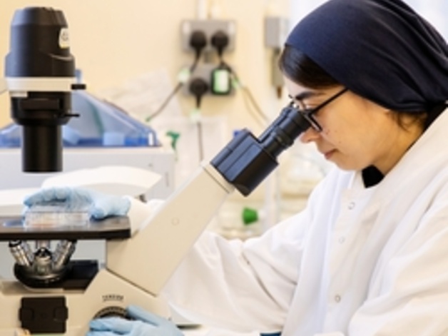 student using a microscope