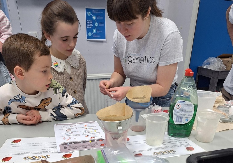 scientist showing children a sample